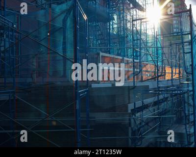 netting or mesh covering scaffolding on a building under construction in New York Stock Photo