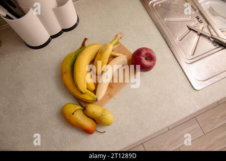 Kitchen Scene with Bananas and Mixed Fruits Stock Photo