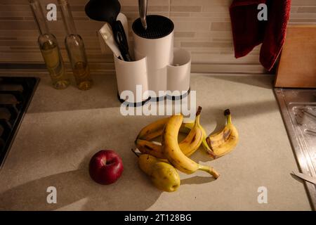 Kitchen Scene with Bananas and Mixed Fruits Stock Photo