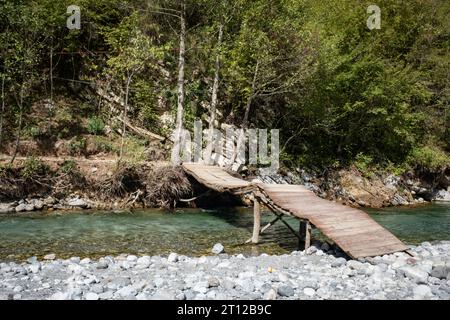 Makeshift wooden bridge over water Stock Photo - Alamy