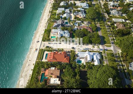 Wealthy neighborhood in small town Boca Grande, Florida with expensive waterfront houses between green palm trees. Development of US premium housing Stock Photo