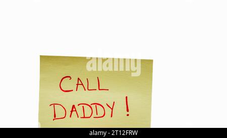 Call daddy handwriting text close up isolated on yellow paper with copy space. Stock Photo