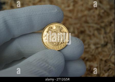 20 Kroner Christian X 1917. An old gold Danish coin in the hands of a numismatist. Stock Photo