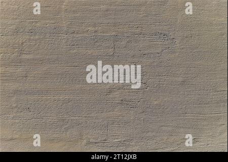 Gray old plaster on the wall. Decorative plaster structure background. Stock Photo