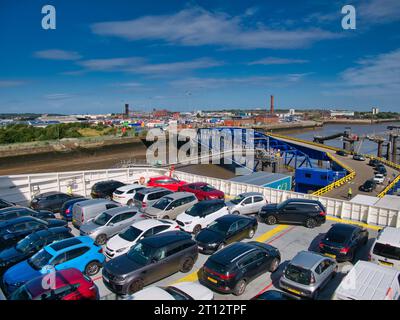 Cars on the upper vehicle deck of the Stena Line ferry leaving Birkenhead on the River Mersey for Belfast in Northern Ireland. The linkspan is in the Stock Photo