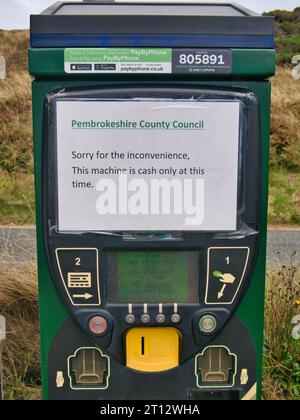 A temporary paper printed sign on a parking meter at Newgale Beach on the Pembrokeshire Coast in Wales Stock Photo