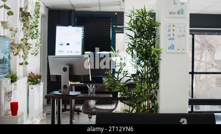 Empty coworking space with desks and computers, professional agency offices and workstations in business department. Modern company building interior, executive profession. Stock Photo