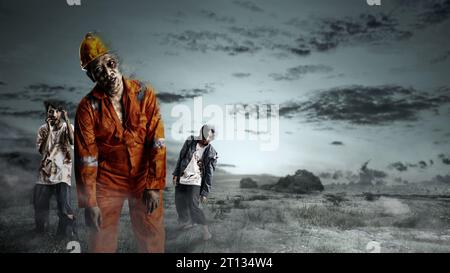 A group of scary zombies with blood and wounds on their bodies are walking on the field. Scary zombie. Halloween concept Stock Photo