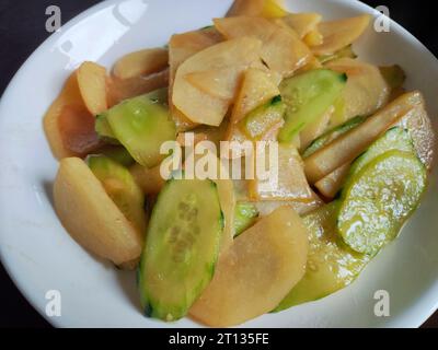 cucumber scrambled with potatoes on the white plate for eating Stock Photo