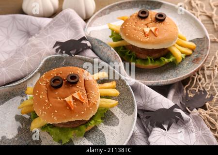 Tasty monster sandwiches and Halloween decorations on table, closeup Stock Photo