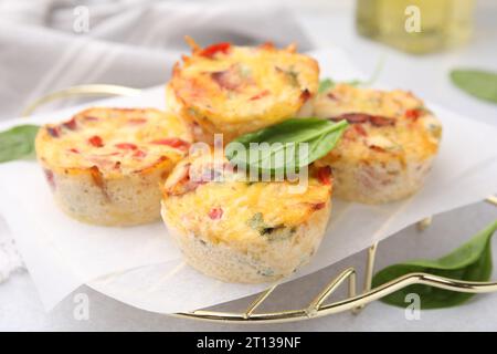 Freshly baked bacon and egg muffins with cheese on table, closeup Stock Photo