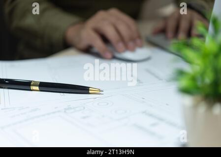 Pen on home interior design engineer document plan architectural. industrial drawing blueprint paper on desk. Stock Photo