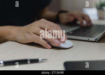 Hand using mouse computer close up on table. Digital technology. Stock Photo