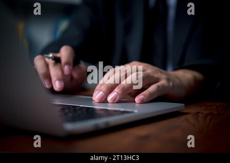 Business man hands working and typing on laptop computer keyboard, searching information, internet social networks, distance job online technology con Stock Photo