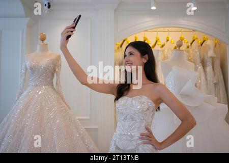 The bride try on her dress at studio. Wedding ceremony and lifestyle concept. Stock Photo