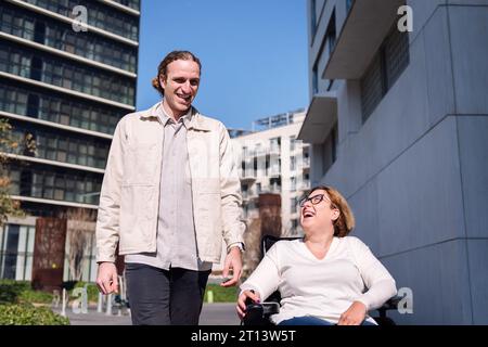 man and woman using wheelchair laughing happy Stock Photo