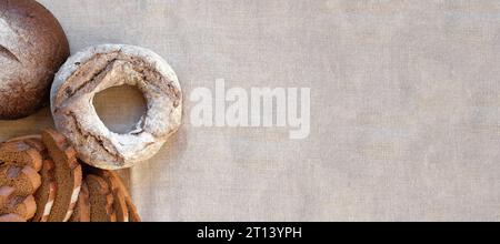Baked bread. Loaf of Bread. Fresh Bakery Products on Wooden Board. Healthy Food Concept. Top View. Flat lay. Slices of Homemade Sourdough Bread with F Stock Photo
