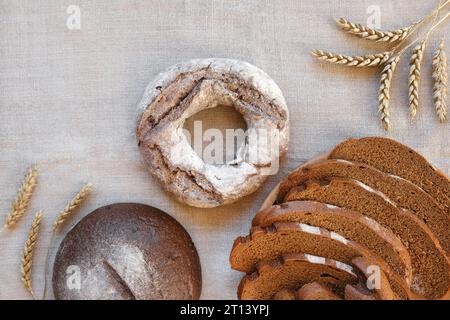 Baked bread. Loaf of Bread. Fresh Bakery Products on Wooden Board. Healthy Food Concept. Top View. Flat lay. Slices of Homemade Sourdough Bread with F Stock Photo