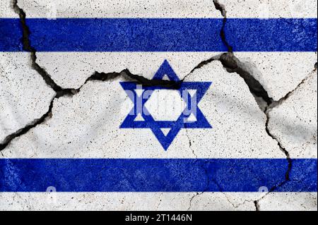 Cracked Israel flag. Concept of war in the Middle East. Israel flag on the cracked earth. Natural disaster concept Stock Photo