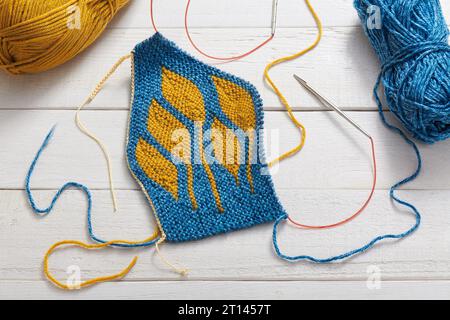 The process of knitting a hat with circular knitting needles using the short rows method Stock Photo