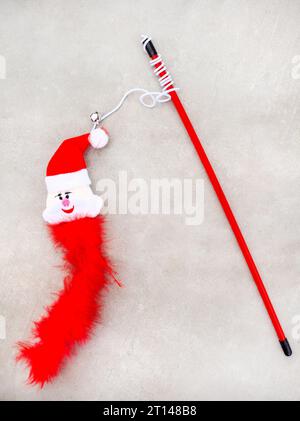 Cat toy Christmas themed. Feather and Santa on stick Stock Photo