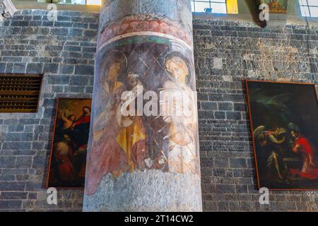 Partly recovered frescos on pillars of the Albenga Cathedral. Cathedral of St Michael Archangel in medieval historical center of Albenga. Italy. Stock Photo