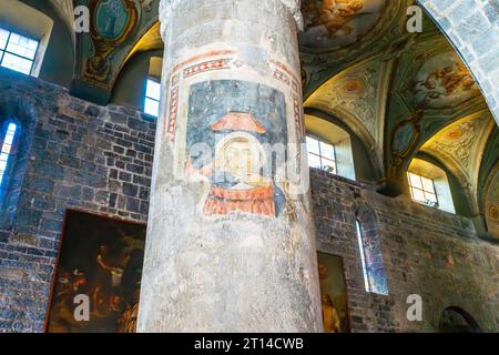 Partly recovered frescos on pillars of the Albenga Cathedral. Cathedral of St Michael Archangel in medieval historical center of Albenga. Italy. Stock Photo