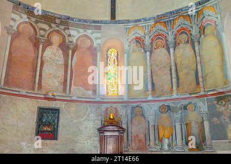 Frescos in high medieval apse are partly visible. Albenga Cathedral.  Cathedral of St Michael Archangel in medieval historical center of Albenga. Stock Photo