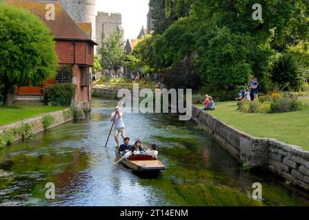People traveling in a punt on the Great Stour river, Canterbury, Kent Stock Photo