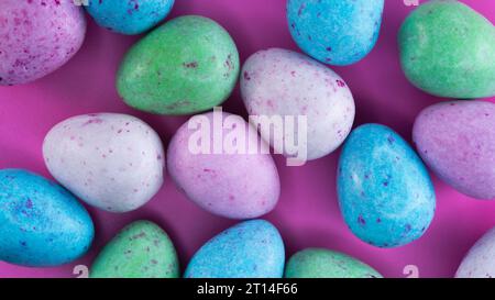 Vibrant and colourful mini milk chocolate eggs with speckled and sweet pastel coloured sugary shells ready for Easter celebrations. Stock Photo