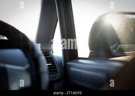 The sunlight hits the side mirror of a car Stock Photo