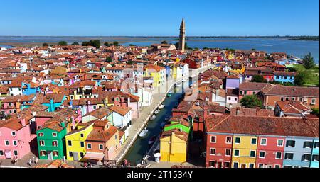 Colorful houses of Burano Island, Church of Saint Martin Bishop, Campanile Pendente, Venice, Italy Stock Photo