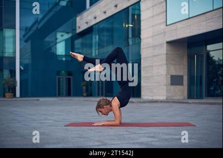 Beautiful Woman Standing In Scorpion Pose Vrischikasana Practicing Yoga  Stock Photo - Download Image Now - iStock