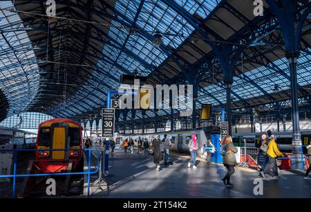 Brighton Railway Station is the southern terminus of the Brighton Main Line, the western terminus of the East Coastway Line and the eastern terminus of the West Coastway Line in England, and the principal station serving the city of Brighton. The station has an impressive large double-spanned curved glass and iron roof covering all of the platforms, which was substantially renovated in 1999 and 200 Stock Photo