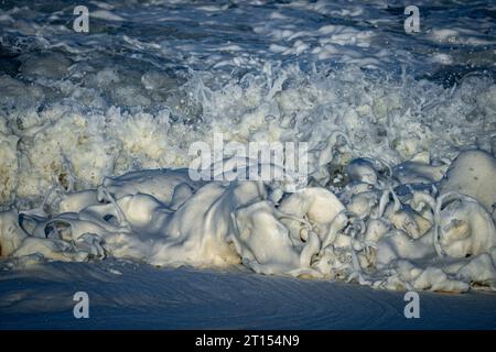 Close-up stock photo of splashing foam bubbles splashing as waves break on the on the rocks Stock Photo