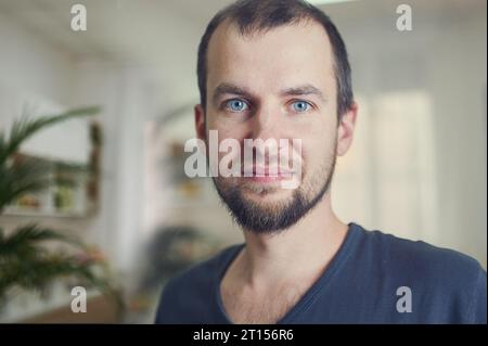Portrait of handsome 35 year old man at home. Blured background Stock Photo