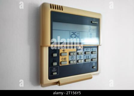 Close-up view of wall-mounted digital thermostat. Stock Photo