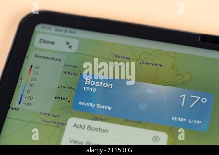 New York, USA - October 8, 2023: Checking temperature outside in Boston city on online app ipad tablet screen close up view Stock Photo