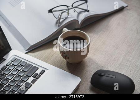 laptop and book, coffee on gray background, Top view of office desk on textured Stock Photo