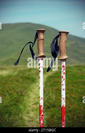 Professional sticks for climbing a mountain on a trail against a blue sky Stock Photo