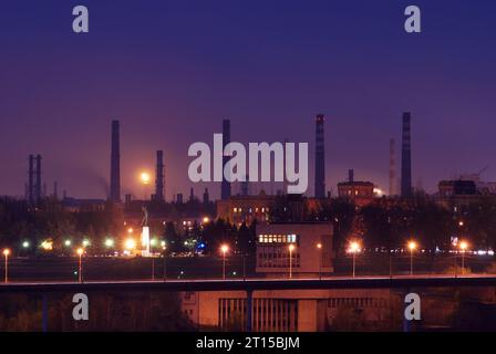 Silhouette of gas turbine electrical power plant against sunset Stock Photo