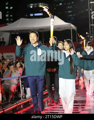 Seoul, South Korea. 11th Oct, 2023. Seoul mayor Oh Se-hoon (L) holds the torch during the celebration in Seoul, South Korea, on Oct. 11, 2023, 100 days ahead of the opening of the 2024 Gangwon Winter Youth Olympic Games. The 2024 Winter Youth Olympics will be held in Gangwon from Jan. 19 to Feb. 1. Credit: Yao Qilin/Xinhua/Alamy Live News Stock Photo