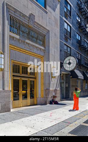 80 8th Avenue, the former Banker’s Trust Building, was designed by William Whitehall and built in 1929. It has a brick façade above a stone base. Stock Photo