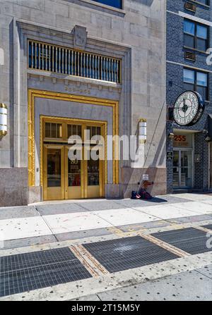 80 8th Avenue, the former Banker’s Trust Building, was designed by William Whitehall and built in 1929. It has a brick façade above a stone base. Stock Photo