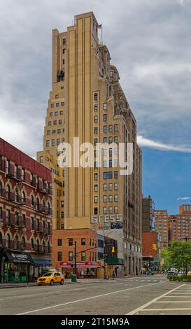 80 8th Avenue, the former Banker’s Trust Building, was designed by William Whitehall and built in 1929. It has a brick façade above a stone base. Stock Photo