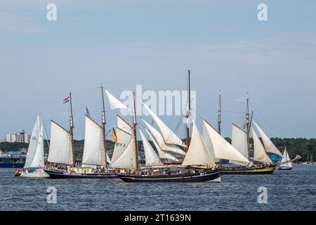 Kiel, Schleswig-Holstein, Germany. 24th June, 2023. The three-masted gaff schooner Albert Johannes (left, built in 1928), the traditional sailing vessel BV2 Vegesack (center, built in 1895) and the two-masted schooner Zuiderzee (right), launched in 1909), take part in Tall Ships Parade (Windjammerparade) in Kieler Förde bay of Baltic Sea with about 60 tall ships, traditional sailing ships, steamboats and hundreds of sailing yachts as part of the Kiel Week (Kieler Woche), an annual sailing event in Kiel. Stock Photo