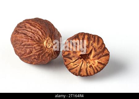 Two nutmegs isolated on a white background. Aromatic spice for cooking Stock Photo