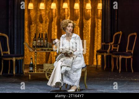 Cottbus, Germany. 10th Oct, 2023. Anne Martha Schuitemaker as Sophie sits on stage during a photo rehearsal for the opera 'Der Rosenkavalier' in the Great House of the Cottbus State Theater. The comedy for music by Richard Strauss and the libretto by Hugo von Hofmannsthal is under the musical direction of General Music Director Alexander Merzyn and will premiere on October 14, 2023. Tomo Sugao directed, Frank Philipp Schlößmann designed the stage, Judith Adam designed the costumes and Diego Leetz set the lights. Credit: Frank Hammerschmidt/dpa/Alamy Live News Stock Photo