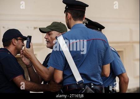 Reggio Calabria, Catanzaro, Italy. 11th Oct, 2023. Police seen holding a man who was provoking Lucano's supporter. The Court of Appeal of Reggio Calabria, guided by magistrate Elisabetta Palumbo, sentenced the former pro-migrant mayor Domenico Lucano to 1 year and six months of reclusion, with suspended pena. In October 2021, Lucano was sentenced by the Court of Locri to 13 years and two months of reclusion, for fraud and mismanagement of funds for migrants. (Credit Image: © Valeria Ferraro/ZUMA Press Wire) EDITORIAL USAGE ONLY! Not for Commercial USAGE! Stock Photo