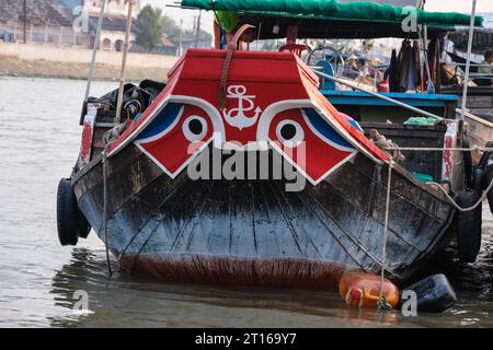Phong Dien Floating Market Scene, near Can Tho, Vietnam. Black Eyes in White Circle on Prow of Boat are Protection against Evil River Spirits. Stock Photo